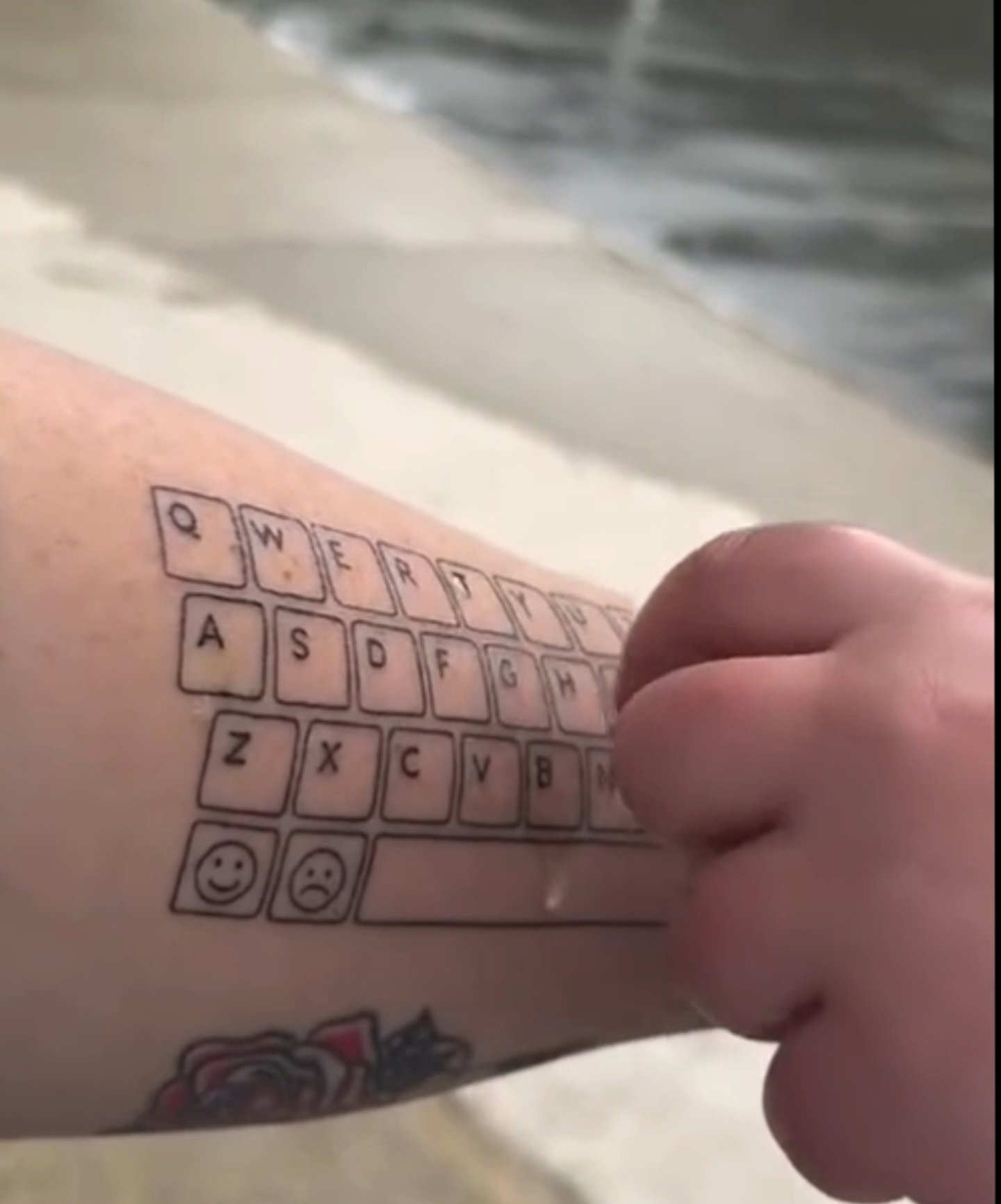 Mom tattoos keyboard on her arm so her nonverbal son will always have a voice